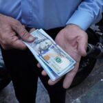 Iran’s currency falls to a new low as nuclear sanctions squeeze its ailing economy
